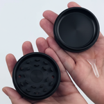 Black grinder with mesh screen and components